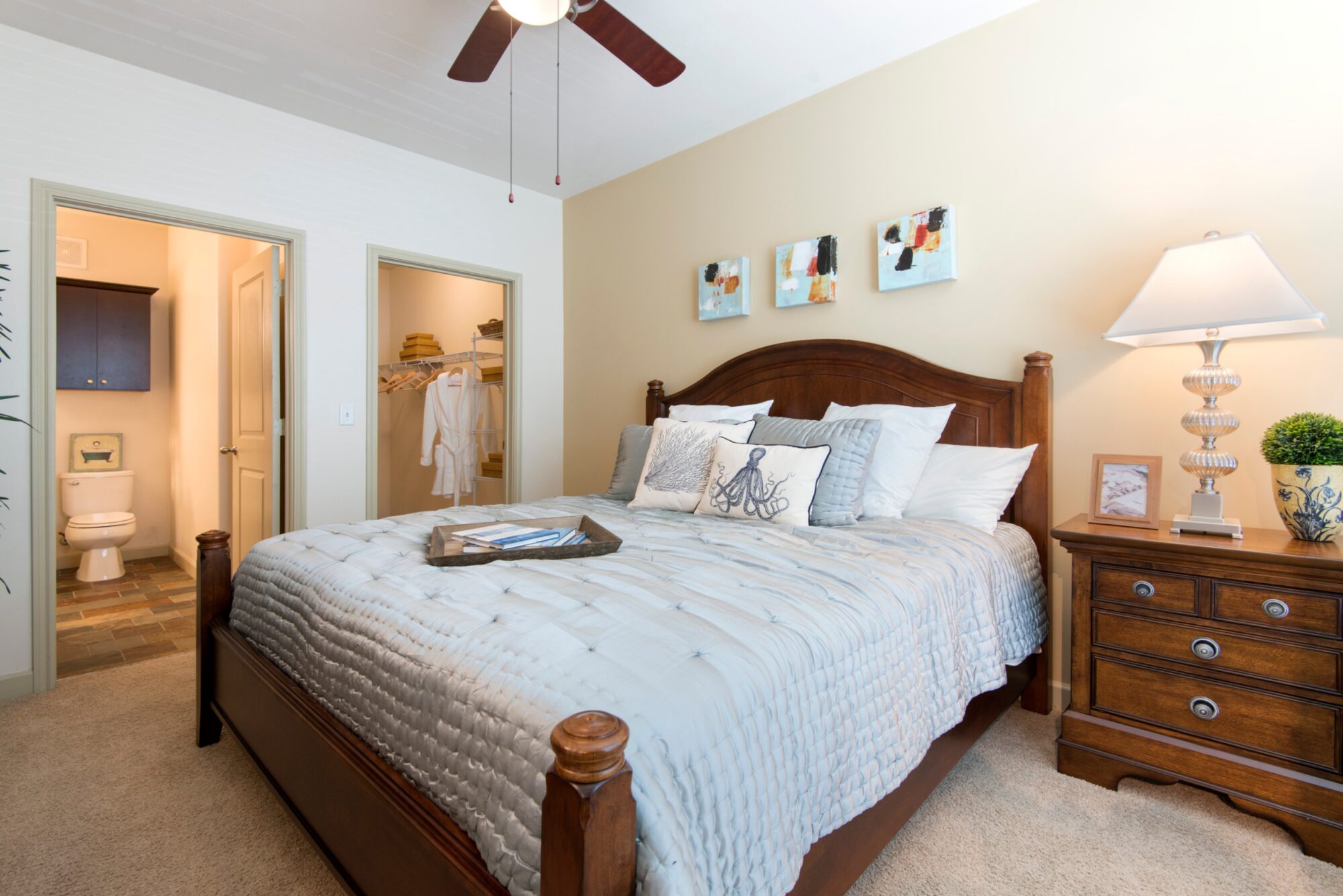 staged bedroom with walk in closet and private bath